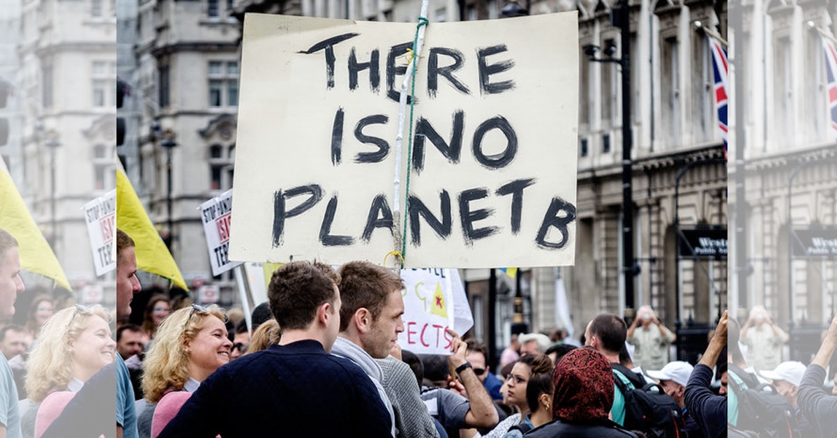 Protester holding banner reading 'There is no planet B'