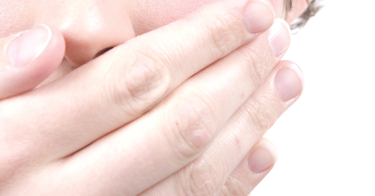 Image of woman with a hand over her mouth being silenced